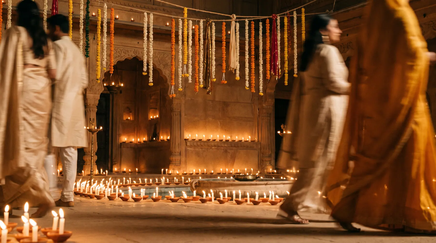 The finished courtyard in full candlelight, guests in soft blur.